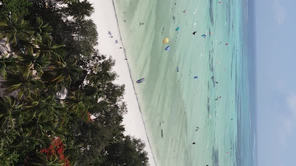 Vertical Video Kitesurfing Near the Shore of Zanzibar Tanzania Aerial View