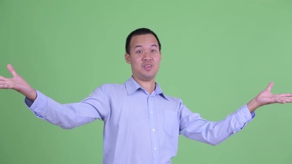 Studio Shot of Happy Asian Businessman with Surprise Gesture