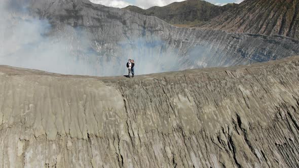 Hikers Couple Take Selfie on Mobile Phone on Mount Bromo Volcano