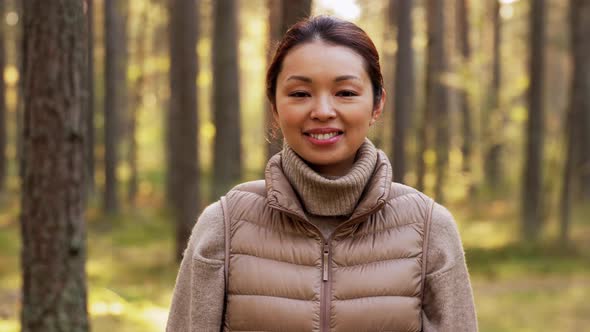 Happy Smiling Asian Young Woman in Forest