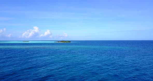 Wide fly over clean view of a summer white paradise sand beach and aqua blue ocean background in hi 