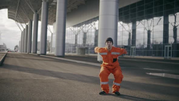 Construction Worker in Uniform Doing Difficult Somersault and Falling Down