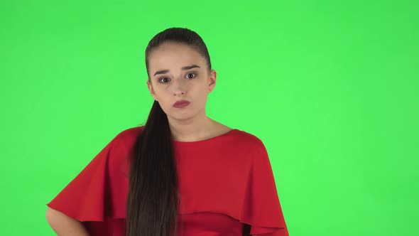 Portrait of Pretty Young Woman Is Scolding, Shaking Her Index Finger and Threatening. Green Screen