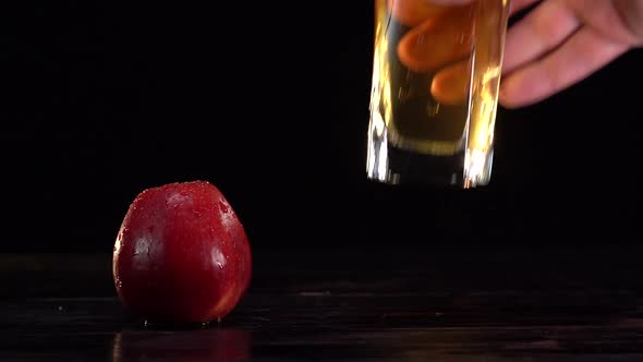 Man's Hand Takes the Glass with Fresh Apple Juice From the Table