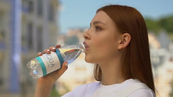 Beautiful Young Female Drinking Mineral Water Outdoors, Hydro Balance, Health