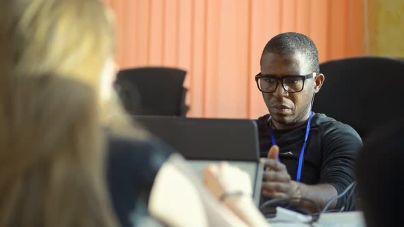 African American Man in Open Space Coworking Office Using Laptop