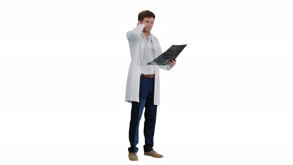 Shocked Male Doctor Looking at Computed Tomography of the Brain on White Background