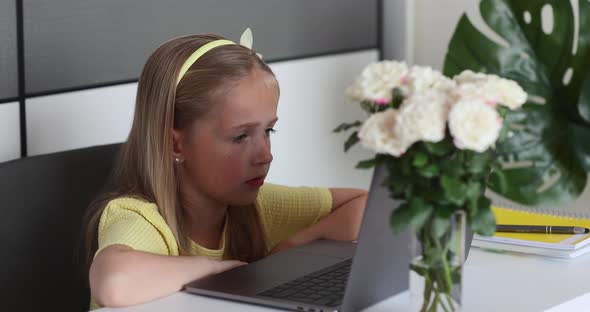 Caucasian Little Girl School Pupil Studying Online From Home Watching Web Class Lesson or Listening