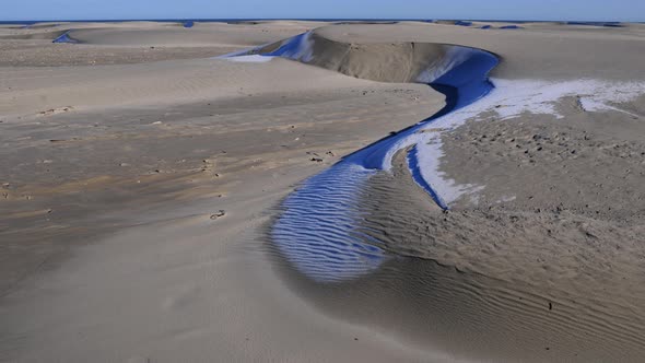 sand dune melting frost sunlight