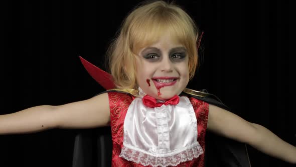 Dracula Child. Girl with Halloween Make-up. Vampire Kid with Blood on Her Face