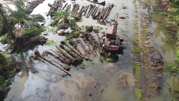 Aerial view an excavator near the land clear of oil palm