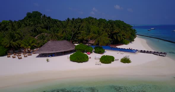 Wide angle fly over tourism shot of a white paradise beach and aqua blue ocean background in high re