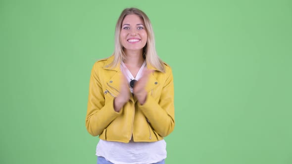 Happy Young Rebellious Blonde Woman Clapping Hands