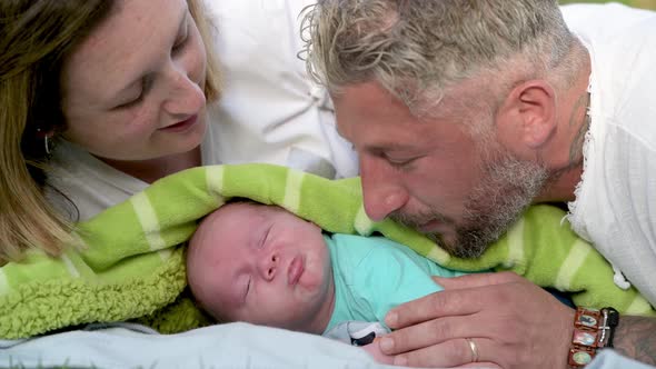 Newborn Baby Kissed By the Parents in the City Park, Slow Motion