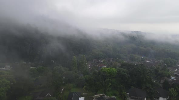 Aerial view of foggy rain forest in near village Indonesia