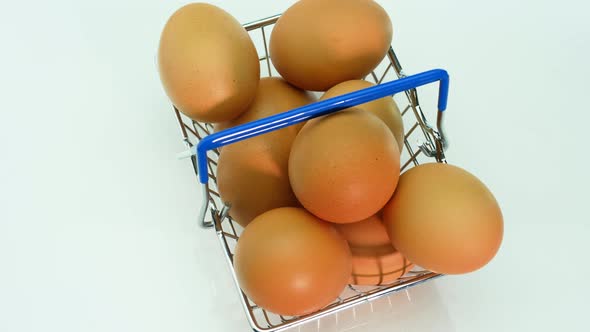 Top View Of Chicken Eggs In A Grocery Cart From A Supermarket On A White Background.