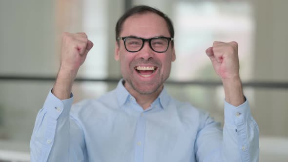 Portrait of Excited Middle Aged Man Celebrating Success