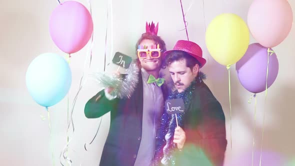 Friends having great time in party photo booth