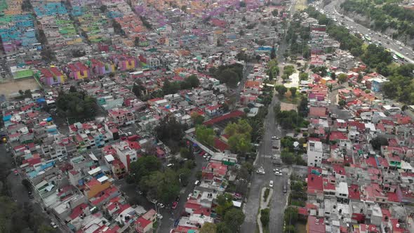 Aerial view of a colorful neighborhood in Mexico City. Drone slowly descending and flying forward