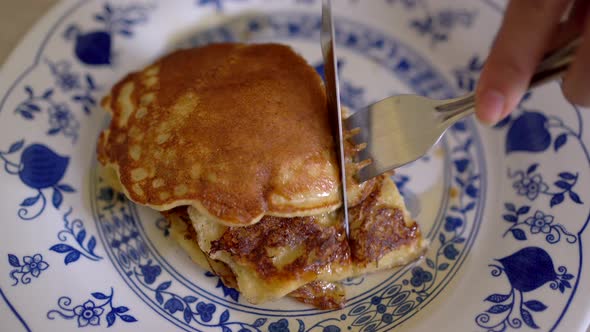 Anonymous person eating tasty pancakes