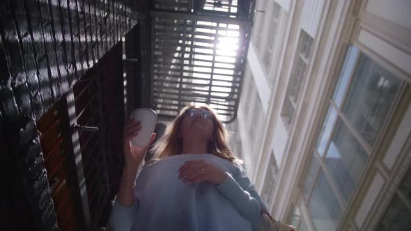 Low Angle View Cheerful Young Woman Walking on Urban City Street Cup of Coffee