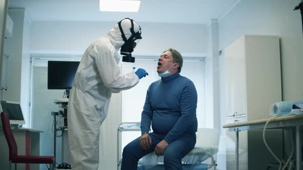 Doctor Is Taking a Mouth Swab of an Elderly Patient. Covid-19, Pandemic, Virus, Coronavirus Disease