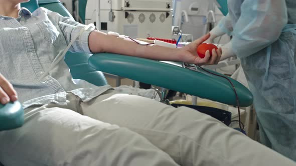 Female Donor Squeezing Stress Ball