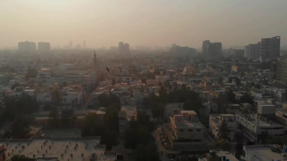 Aerial View Of Air Pollution Over Karachi City In Pakistan. Parallax Follow Shot