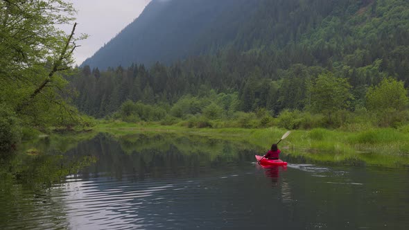 Adventure Caucasian Adult Woman Kayaking in Red Kayak