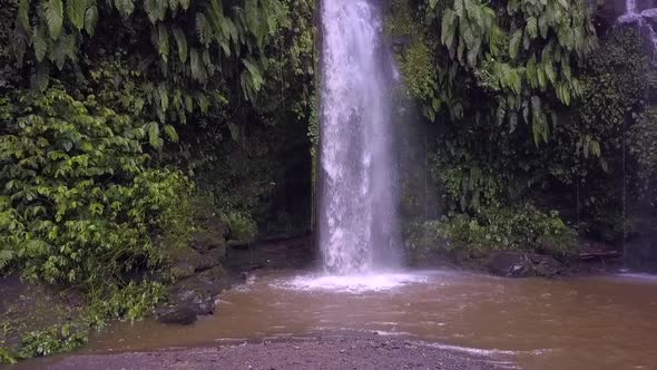 Slow motion native natural shower.Marvelous aerial view flight pull out drone footageWaterfall Ben