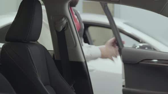 Portrait Attractive Confident Bearded Businessman Sits in the Vehicle and Inspects Newly Purchased