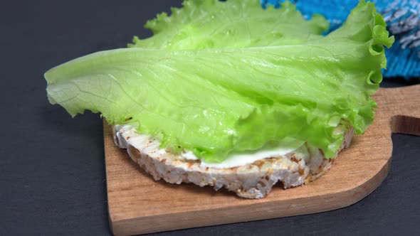 Bread Sandwich with Raw Salmon, Cream Cheese, Leaf Lettuce, and Chia Seeds. Closeup. Healthy Snack