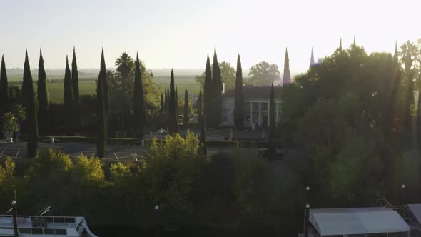 Aerial of elegant Grand Island Mansion wedding venue with morning sun rays