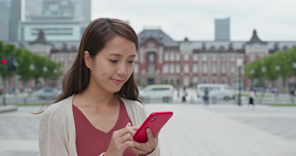 Woman use of smart phone in Tokyo station