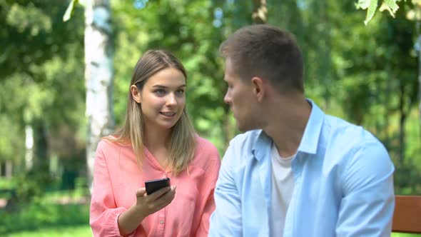 Angry Woman Shouting on Husband, Looking Through Photos on His Phone, Jealousy