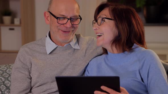 Happy Senior Couple with Tablet Pc at Home