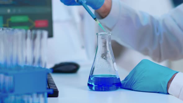 Close Up of Scientist Filling Test Tube with Liquid Using Pipette