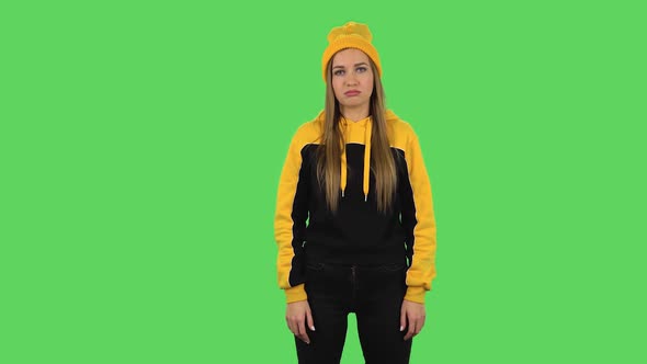 Modern Girl in Yellow Hat Is Tired. Green Screen