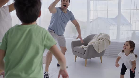 Joyful Family with Children During Game at Home