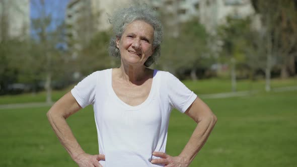 Smiling Senior Woman Posing on Green Meadow