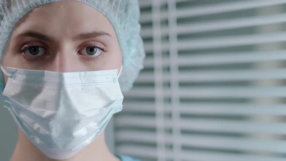 Portrait of Female Doctor in Protective Face Mask and Uniform at Work