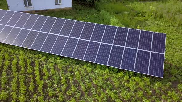 Blue solar panels for clean energy on green grass.