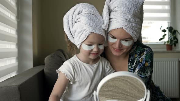 Young Woman and Her Little Daughter Are Doing Beauty Treatments After a Shower