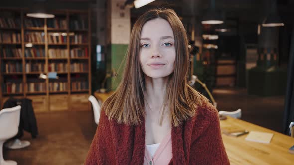 Portrait of Attractive Young Caucasian Woman Student Standing at Library