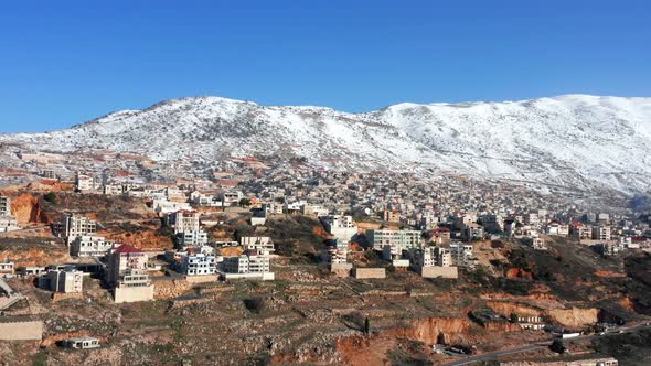 Hermon mountain ridge covered with snow during 2022 winter, with the town houses of Majd al Shams.