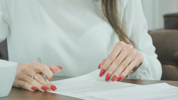 Woman Hand Putting Signature on Contract