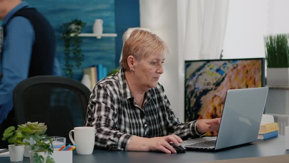 Overworked Senior Woman Working From Home at Laptop