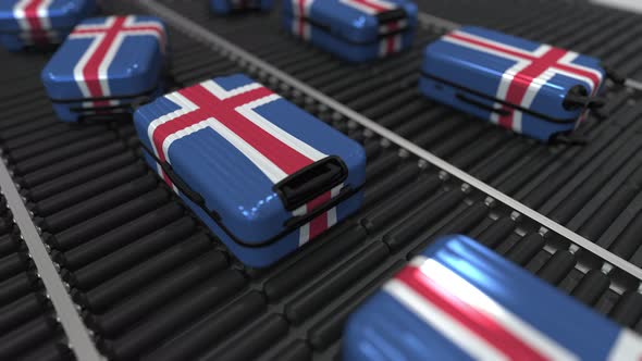 Many Suitcases with Flag of Iceland on Roller Conveyor