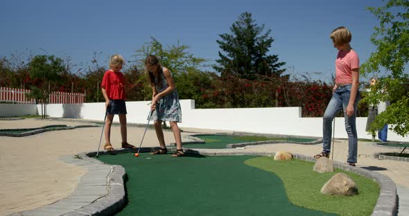 Kids playing miniature golf in the garden