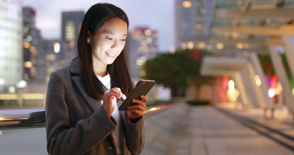 Businesswoman use of cellphone at night